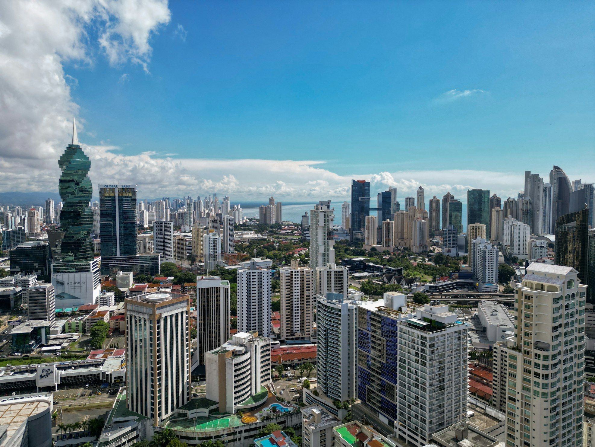 Panama City skyline in daylight, with the twisting F&F Tower and the Pacific Ocean beyond