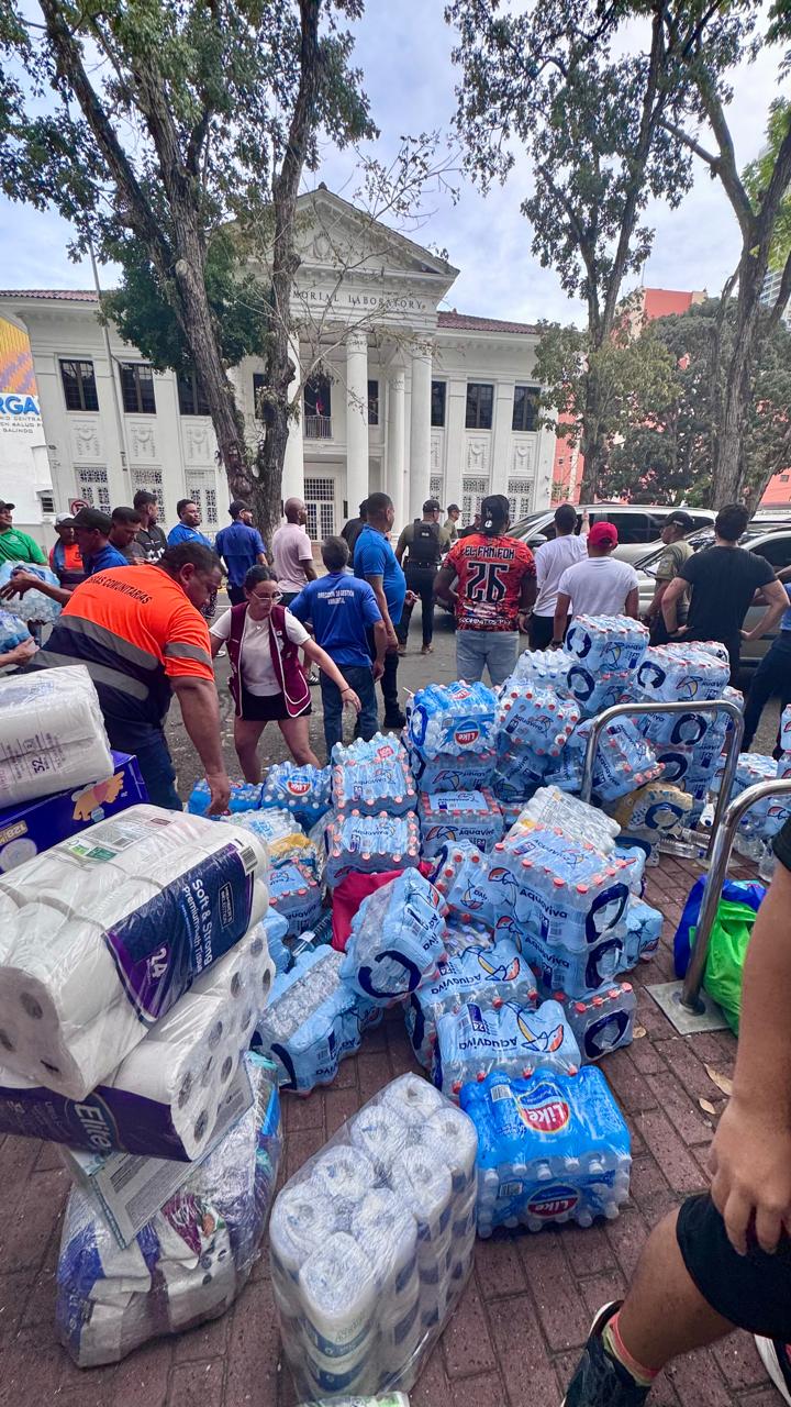 Volunteers among donated bottled water and hygiene supplies in Panama City